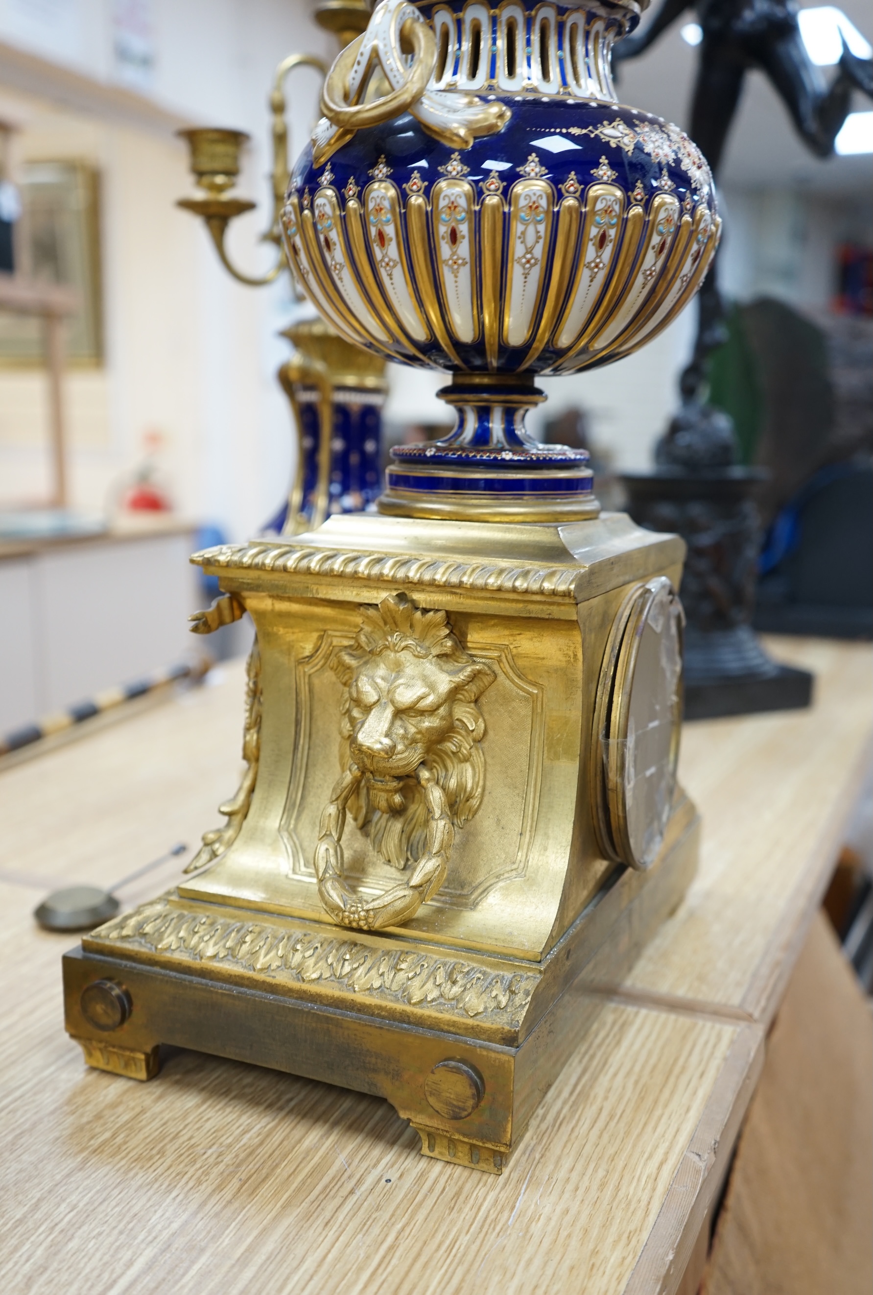 A 19th century Sevres style jewelled porcelain and ormolu matched clock garniture, striking on a bell, with pendulum, 51cm high. Condition - fair to good, minor restoration, untested